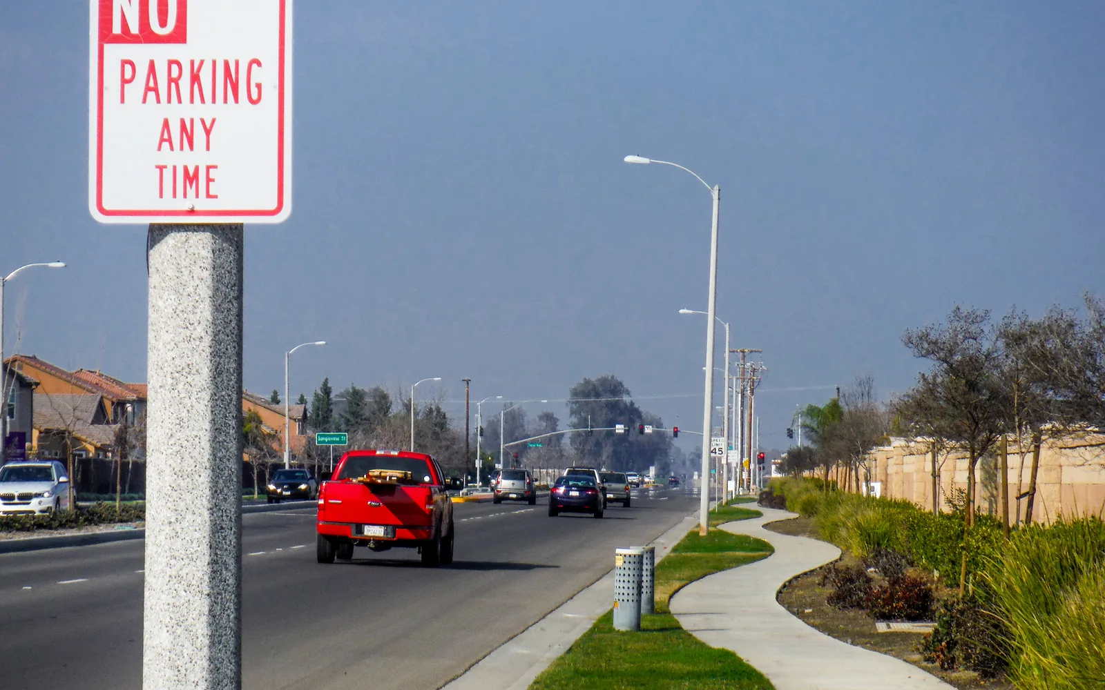 Meandering sidewalk along 12th Avenue in Hanford, California, with historic streetscape